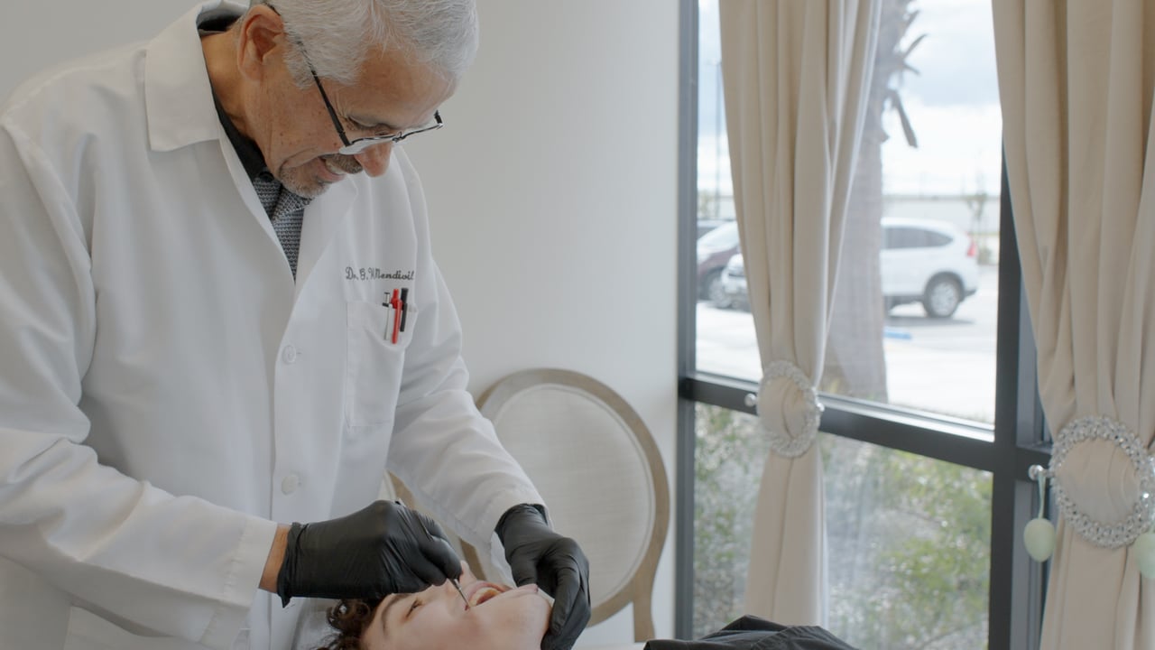 Dr. Mendivil in consultation with a patient